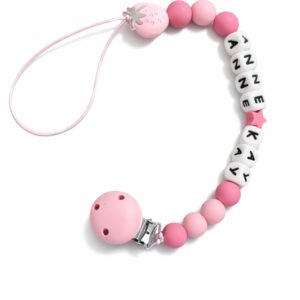 A collection of handmade personalised dummy clips and keyrings in various colours.